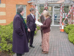 Catherine Dean passing the signatures to Roger Harborough
